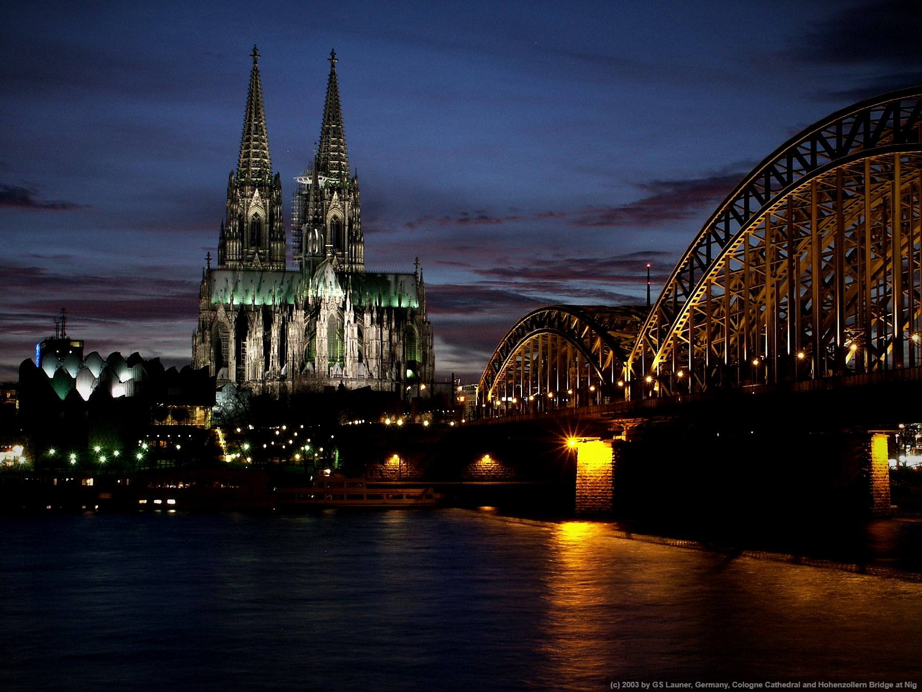 Cologne Cathedral and Hohenzollern Bridge at Nig in Cologne Cathedral and Hohenzollern Bridge, Cologne, North Rhine-Westphalia, Germany, Germany